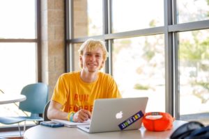 Male student studying at his laptop