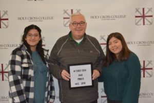 Father David T. Tyson, C.S.C., with 2 female students