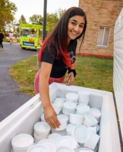 Female student enjoys ice cream outdoors