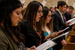 Students singing at Mass