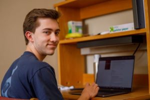 Male student on a laptop