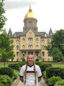 Student Tori Jones in front of the Golden Dome.