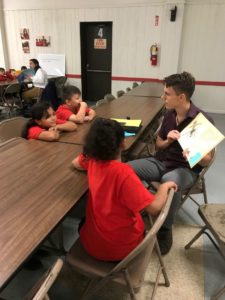 Pictured is student Zechariah Ritchie with children from St. Adalberts.