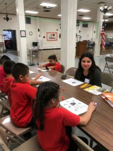 Student Mia Wenzler works with children from St. Adalbert's grade school.