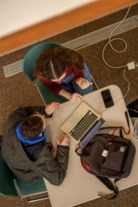 Aerial picture of students working at a computer.