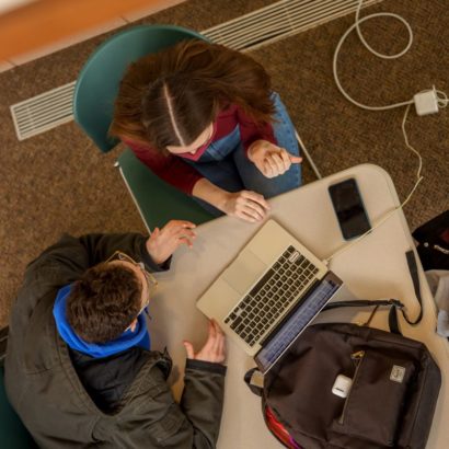 Aerial picture of students working at a computer.