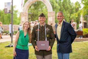 ROTC student with family at graduation.