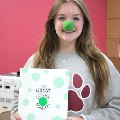 Pictured is student Sarah Davis ’25 promoting The Great Logan Nose-On.